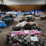 Bodies found in the ruins of the devastated residential area of Otsuchi are collected in a sports hall
