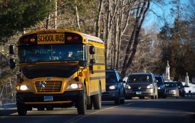 A school bus carrying children from Sandy Hook Elementary School makes its way to their new school in Monroe as they leave Newtown