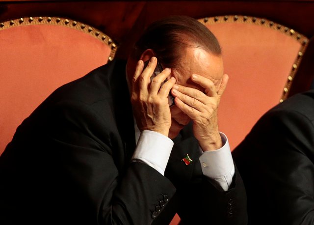 Italian center-right leader Berlusconi uses mobile phone during confidence vote at the Senate in Rome