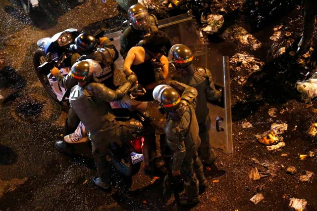 National guards escort a detainee after an anti-government protest at Altamira square in Caracas