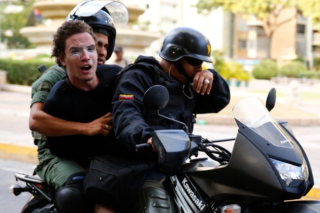 National guards transport an anti-government protester detainee during a protest against Nicolas Maduro's government in Caracas