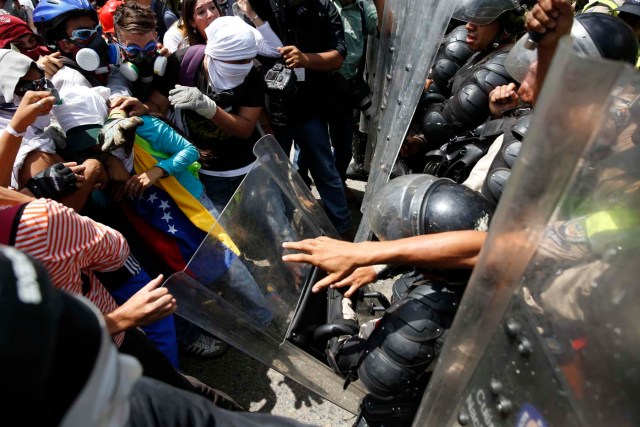 Anti-government protesters clash with riot police in Caracas