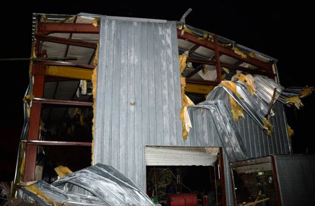 Debris is seen at a damaged business after a tornado hit the town of Mayflower, Arkansas