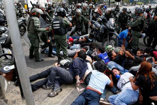 National guards detain a group of anti-government protesters during a protest against Venezuelan President Maduro's government in Caracas