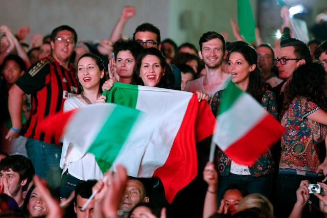 People cheer as they watch the 2014 World Cup soccer match between Italy and England during a public viewing event in downtown Rome