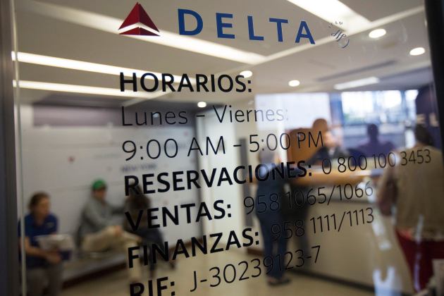 Customers wait their turn to be served at at the Delta airlines office in Caracas