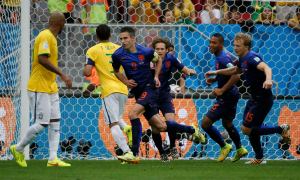 Robin van Persie of the Netherlands celebrates after scoring his penalty against Brazil during their 2014 World Cup third-place playoff at the Brasilia national stadium in Brasilia
