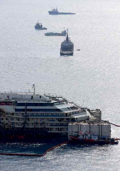 Cruise liner Costa Concordia is seen surrounded by tugboats during a refloat operation at Giglio harbour at Giglio Island