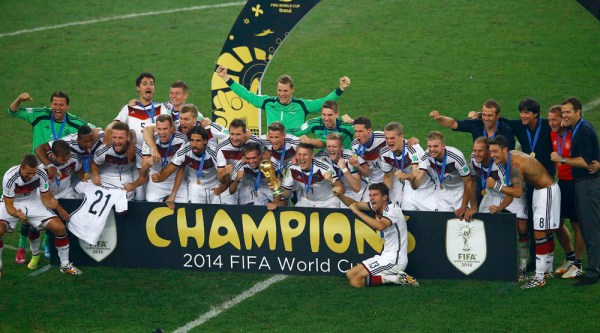 Germany's team poses with the World Cup trophy after winning their 2014 World Cup final against Argentina at the Maracana stadium in Rio de Janeiro