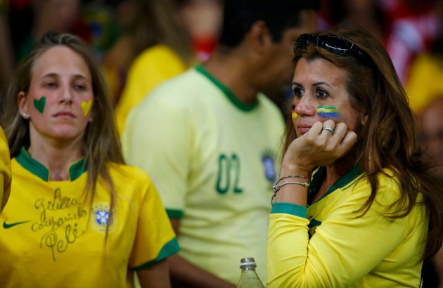 Brazil fans react at half-time during the team's  2014 World Cup semi-finals against Germany at the Mineirao stadium in Belo Horizonte
