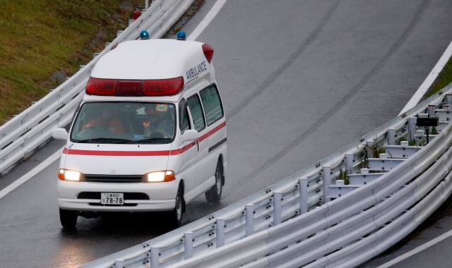 An ambulance is dispatched after the race was stopped following a crash by Marussia Formula One driver Jules Bianchi of France at the Japanese F1 Grand Prix at the Suzuka Circuit