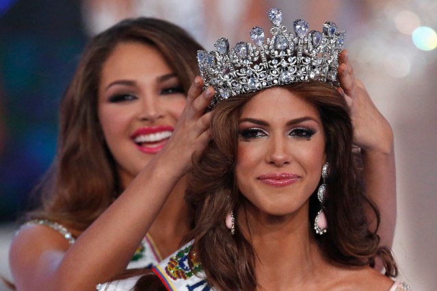 Miss Venezuela 2013 Migbelis Castellanos crowns contestant Miss Guarico, Mariana Jimenez, after she won the Miss Venezuela 2014 pageant in Caracas