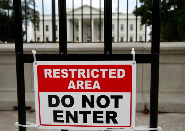 A sign is posted on a fence outside the White House in Washington