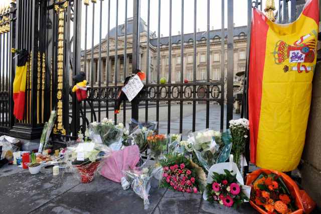 Spanish and Belgian flags are placed with flowers outside the Royal Palace in honour of Queen Fabiola in Brussels