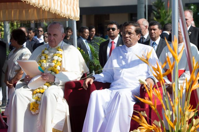 Pope Francis sits next to Sri Lankan President Maithripala Sirisena as he arrives at the Colombo airport