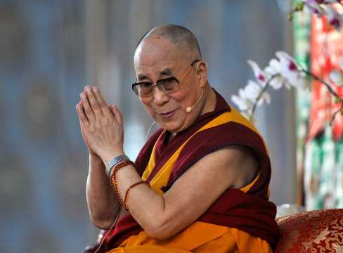 Exiled Tibetan spiritual leader, the Dalai Lama, gestures as he speaks to his followers during the Jangchup Lamrim teaching session at the Gaden Jangtse Thoesam Norling Monastery in Mundgod