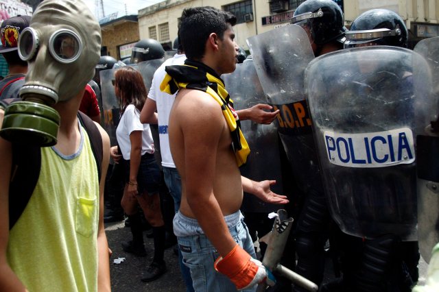 Opposition demonstrators talk  to police during a march against President Nicolas Maduro's government in San Cristobal