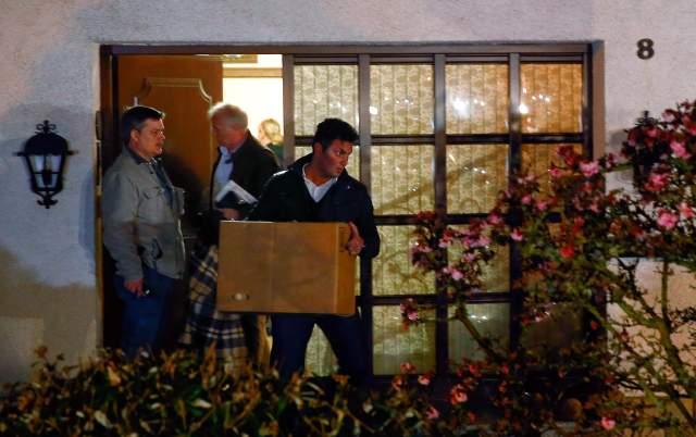 German police officers carry boxes out of a house believed to belong to the parents of crashed Germanwings flight 4U 9524 co-pilot Andreas Lubitz in Montabaur