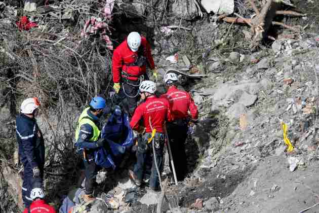 French rescue workers inspect the remains of the Germanwings Airbus A320 at the site of the crash