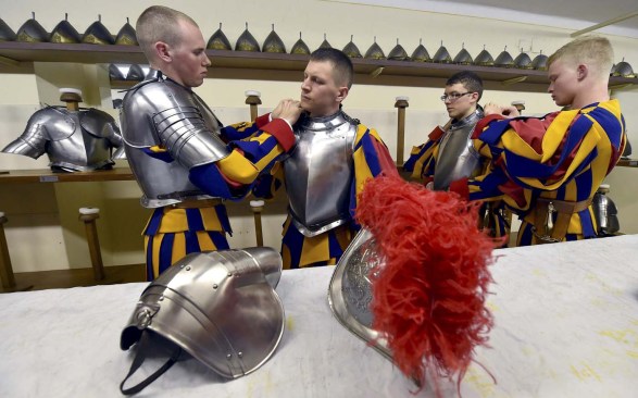 New Vatican Swiss guards adjust their uniforms prior to a swearing-in ceremony at the Vatican