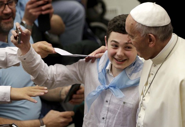 Child takes a selfie with Pope Francis as he leads a special audience for the Lazio sport association in Paul VI's hall at the Vatican