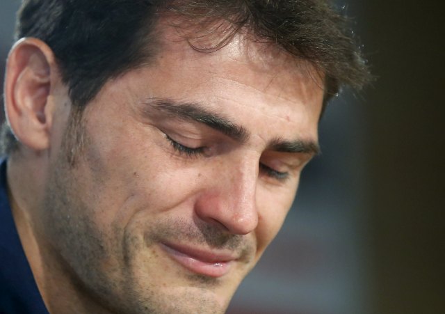 Departing Real Madrid captain and goalkeeper Iker Casillas reacts as he tries to read a statement at Santiago Bernabeu stadium in Madrid, Spain