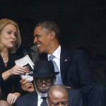 U.S. President Obama shares a laugh with Danish PM Thorning-Schmidt as his wife, U.S. first lady Michelle looks on during a memorial service for late South African President Nelson Mandela in Johannesburg