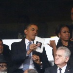 U.S. President Obama and his wife, U.S. first lady Michelle talk to senior advisor Jarrett at a memorial service for late South African President Nelson Mandela in Johannesburg