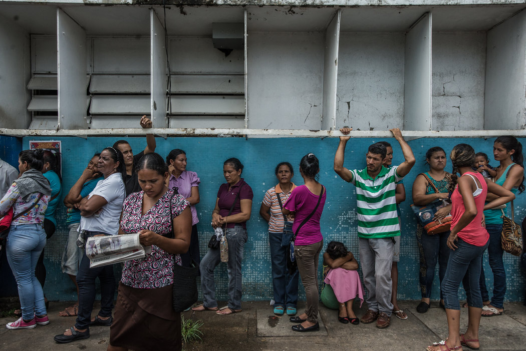 Centenares de personas con síntomas de malaria llenan las salas de espera de una clínica en Ciudad Guayana, en mayo. Credit Meridith Kohut para The New York Times