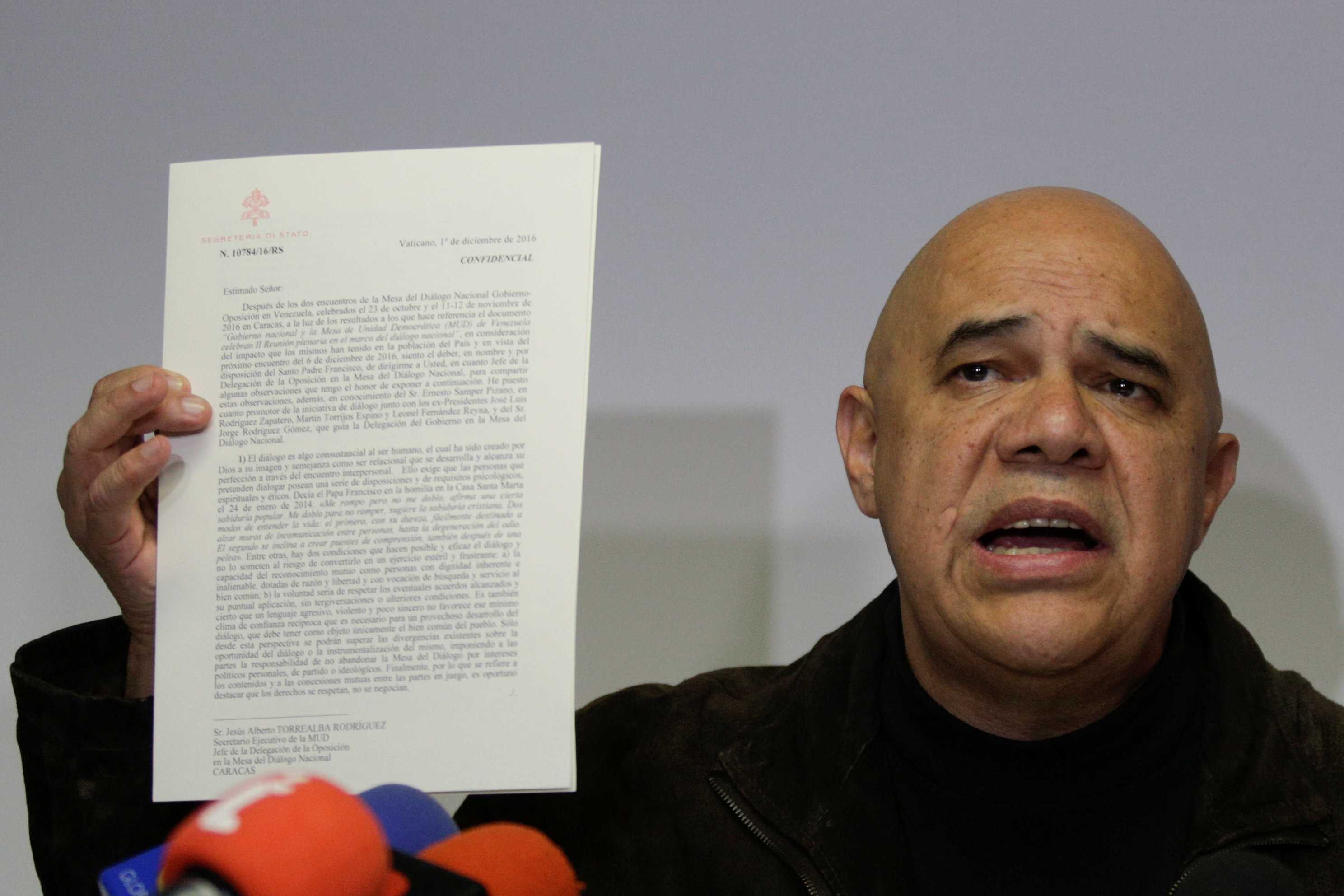 Jesus Torrealba, secretary of the MUD, holds a letter from Vatican Secretary of State Cardinal Pietro Parolin as he talks to the media during a news conference in Caracas