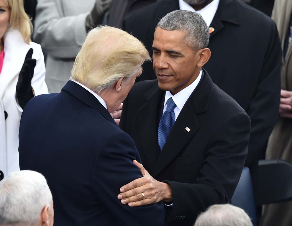 President-elect Donald Trump(L) is greeted by US President Barack Obama(R) as he arrives on the platform of the US Capitol in Washington, DC, on January 20, 2017, before his swearing-in ceremony to be the 45th president of the US. / AFP PHOTO / Paul J. Richards