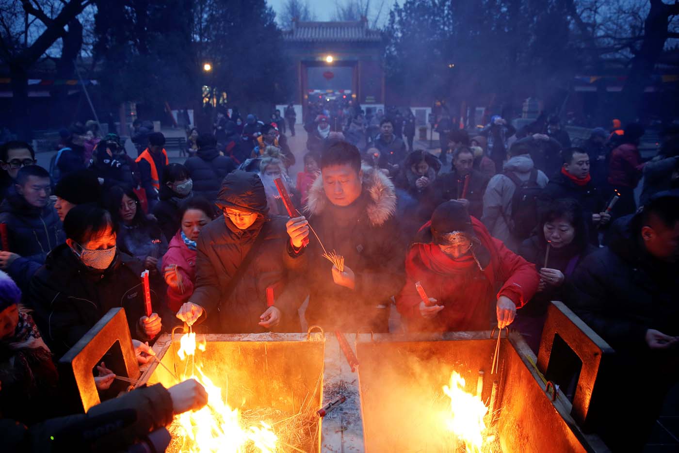 People burn incense sticks and pray for good fortune at Yonghegong Lama Temple on the first day of the Lunar New Year of the Rooster in Beijing, China January 28, 2017. REUTERS/Damir Sagolj