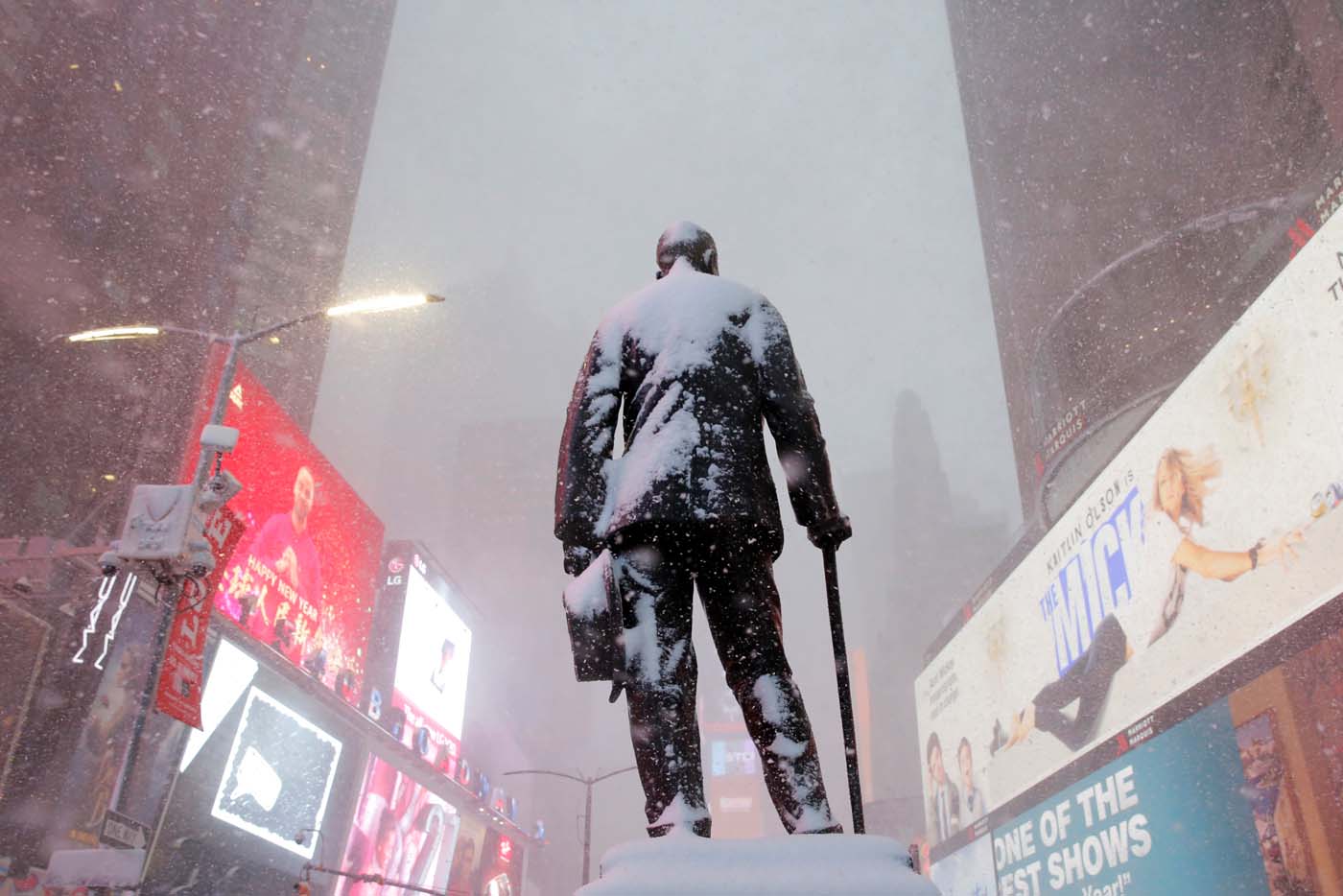 A statue of American composer, playwright, actor, and producer George M. Cohan stands in Times Square as snow falls in Manhattan, New York, U.S. February 9, 2017. REUTERS/Andrew Kelly