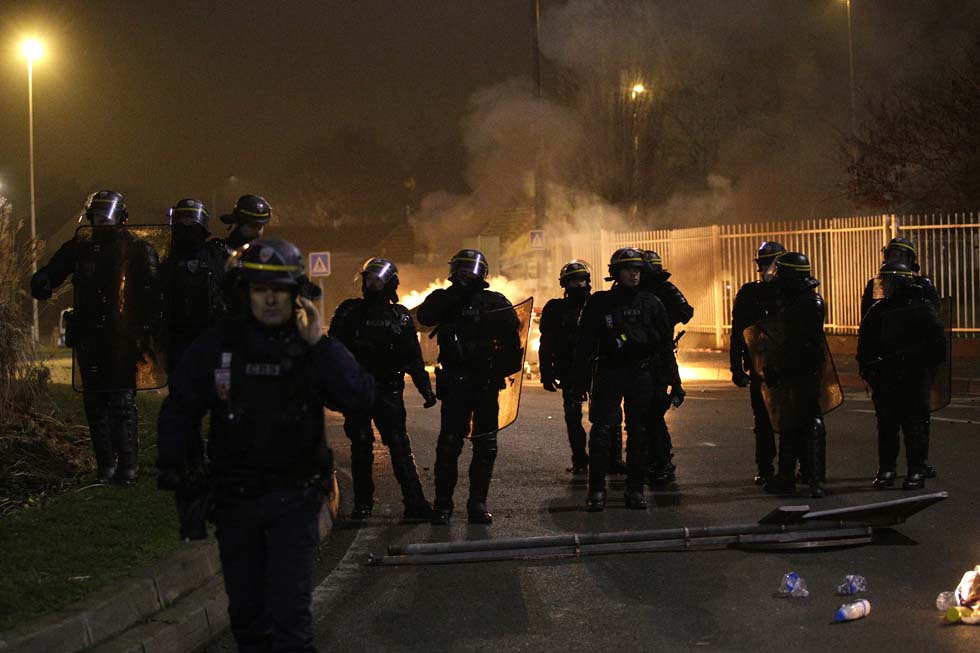 Anti riot police officers stand guard during a protest in Bobigny, a district of northeast Paris, to denounce police brutality after a black man was allegedly sodomised with a baton during an arrest while in their custody in Paris on February 11, 2017. A 22-year-old black youth worker named as Theo, a talented footballer with no criminal record, required surgery after his arrest on February 2, 2017 when he claims a police officer sodomized him with his baton. One officer has been charged with rape and three others with assault over the incident in the tough northeastern suburb of Aulnay-sous-Bois which has revived past controversies over alleged police brutality. / AFP PHOTO / GEOFFROY VAN DER HASSELT