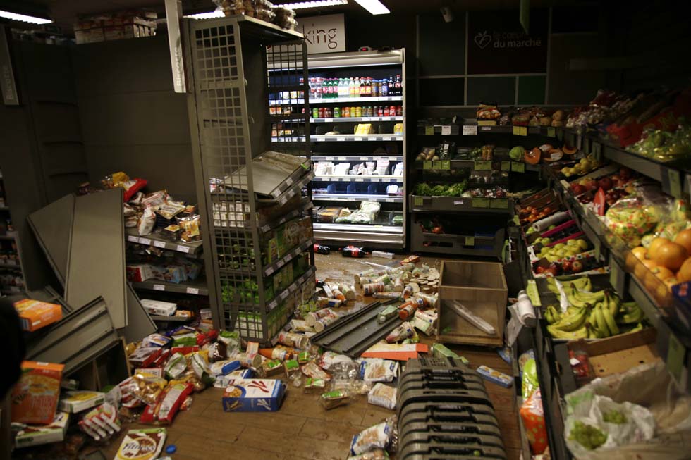This picture taken on February 11, 2017 shows the inside of a vandalised Franprix supermarket during a protest in Bobigny, a district of northeast Paris, to denounce police brutality after a black man was allegedly sodomised with a baton during an arrest while in their custody in Paris. A 22-year-old black youth worker named as Theo, a talented footballer with no criminal record, required surgery after his arrest on February 2, 2017 when he claims a police officer sodomized him with his baton. One officer has been charged with rape and three others with assault over the incident in the tough northeastern suburb of Aulnay-sous-Bois which has revived past controversies over alleged police brutality. / AFP PHOTO / GEOFFROY VAN DER HASSELT