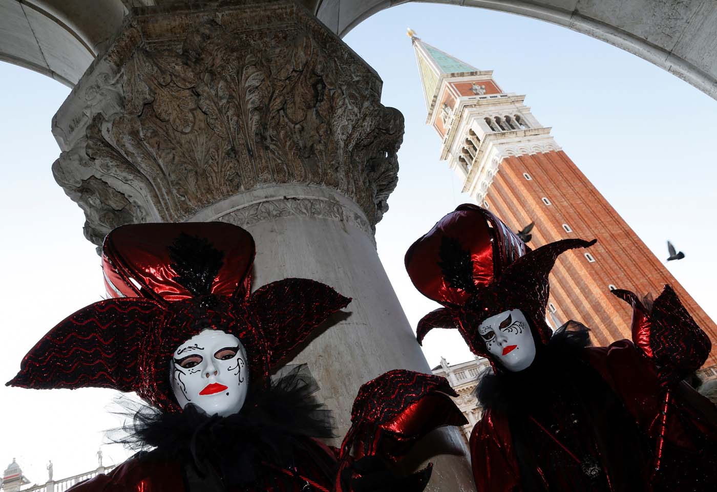 Revellers pose in St. Mark's Square during the Carnival in Venice, Italy February 18, 2017 REUTERS/Alessandro Bianchi