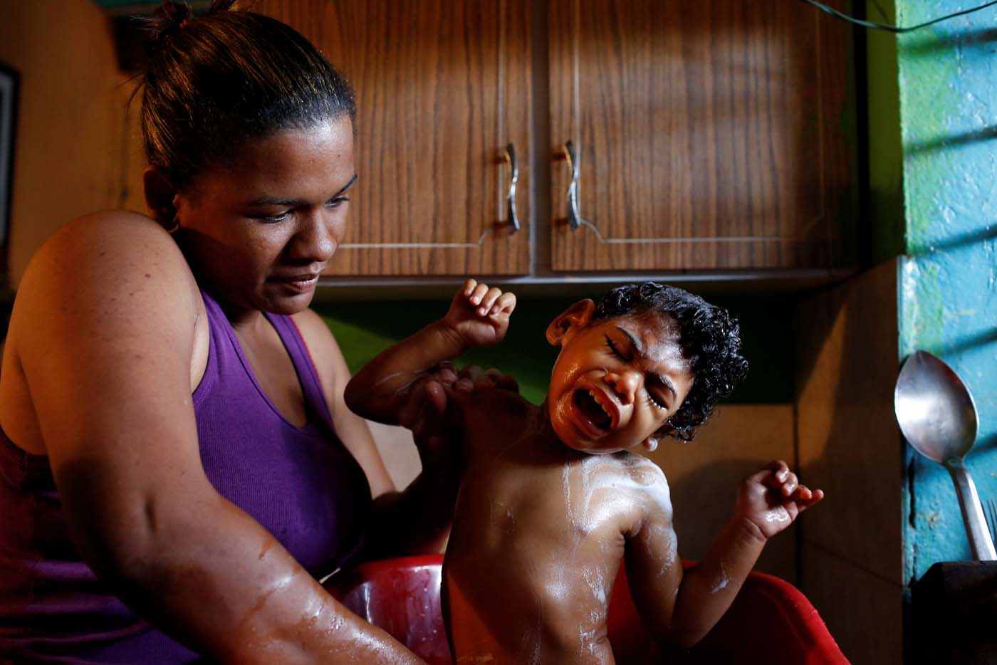 Tatiana Rocha, baths her son Kaleth Heredia, 2, a neurological patient being treated with anticonvulsants, at their house in Caracas, Venezuela February 8, 2017. REUTERS/Carlos Garcia Rawlins  TPX IMAGES OF THE DAY     SEARCH "EPILEPSY CARACAS" FOR THIS STORY. SEARCH "WIDER IMAGE" FOR ALL STORIES.