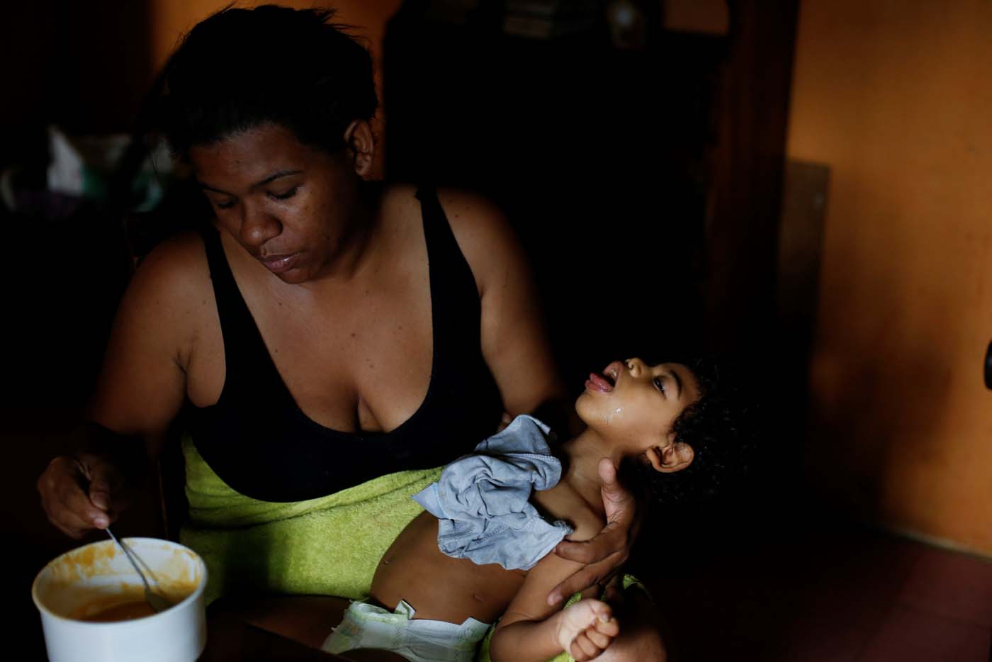 Tatiana Rocha feeds her son Kaleth Heredia, 2, neurological patient being treated with anticonvulsants, at their house in Caracas, Venezuela February 3, 2017. REUTERS/Carlos Garcia Rawlins    SEARCH "EPILEPSY CARACAS" FOR THIS STORY. SEARCH "WIDER IMAGE" FOR ALL STORIES.