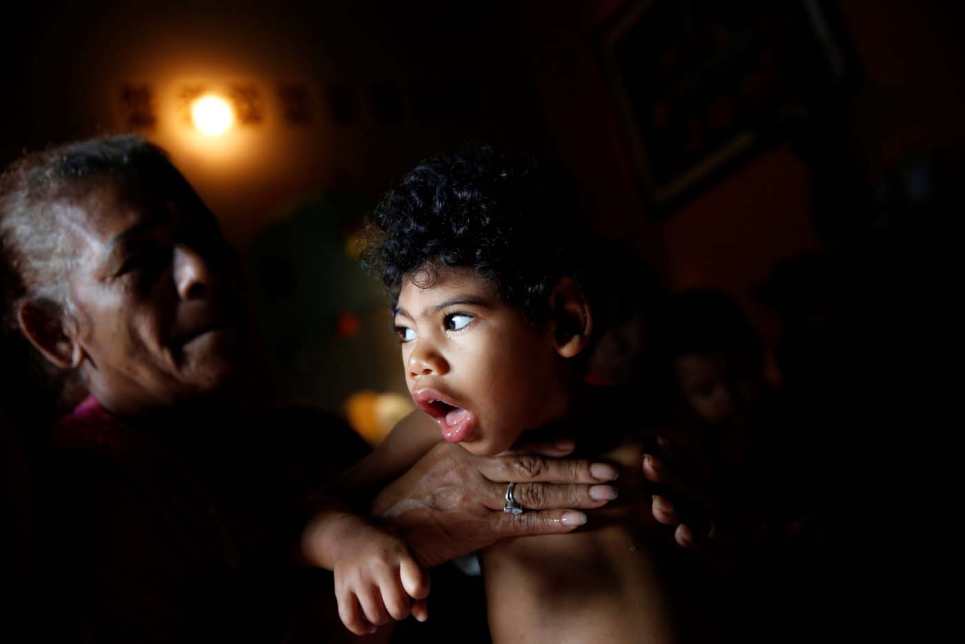 Kaleth Heredia, 2, neurological patient being treated with anticonvulsants, is carried by his grandmother Isabel Buelvas at their house in Caracas, Venezuela January 30, 2017. REUTERS/Carlos Garcia Rawlins   SEARCH "EPILEPSY CARACAS" FOR THIS STORY. SEARCH "WIDER IMAGE" FOR ALL STORIES.