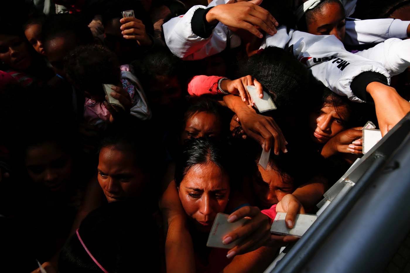 Women queues on the street as they try to buy diapers outside a pharmacy in Caracas, Venezuela March 18, 2017. REUTERS/Carlos Garcia Rawlins SEARCH "GARCIA QUEUEING" FOR THIS STORY. SEARCH "WIDER IMAGE" FOR ALL STORIES.