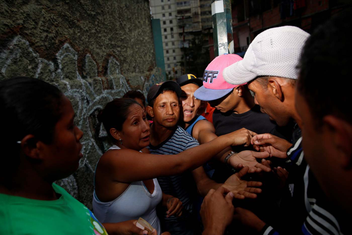 People argue while they queue on the street as they try to buy food outside a supermarket in Caracas, Venezuela March 17, 2017. REUTERS/Carlos Garcia Rawlins SEARCH "GARCIA QUEUEING" FOR THIS STORY. SEARCH "WIDER IMAGE" FOR ALL STORIES.