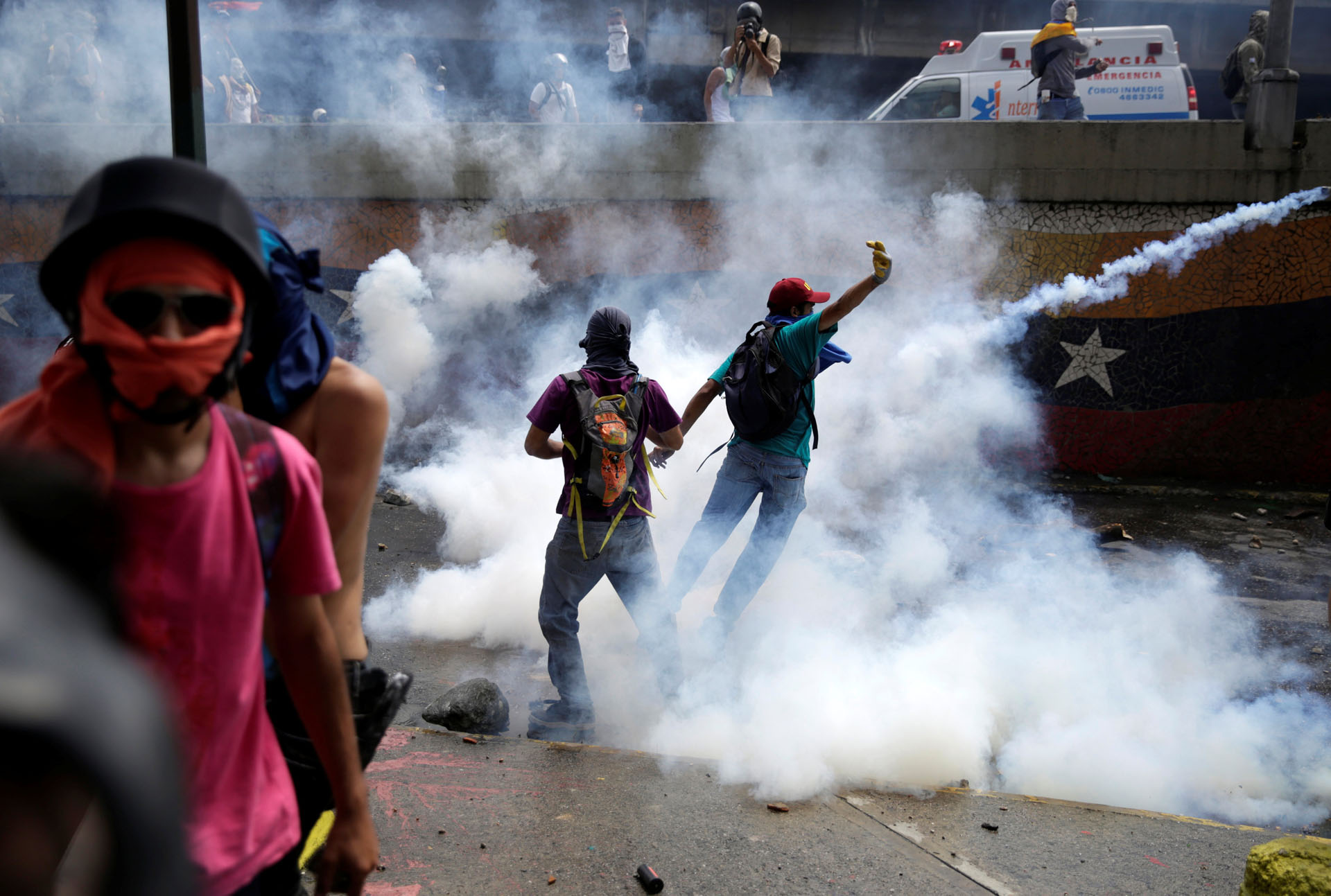 Demonstrators are seen amidst tear gas fired by police during an opposition rally in Caracas, Venezuela, April 6, 2017. REUTERS/Marco Bello