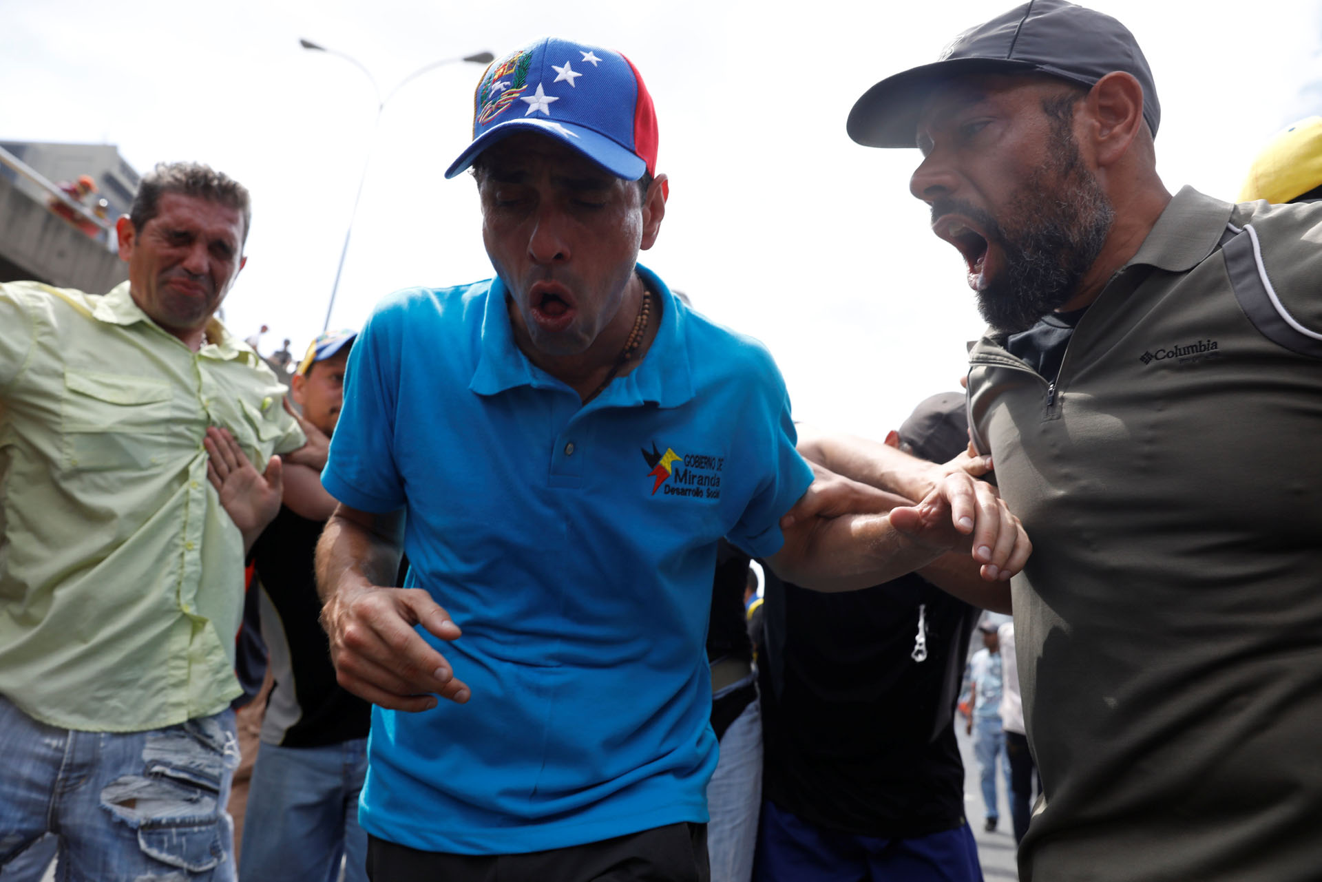 Opposition leader Henrique Capriles reacts after being exposed to tear gas during an opposition rally in Caracas, Venezuela April 6, 2017. REUTERS/Carlos Garcia Rawlins