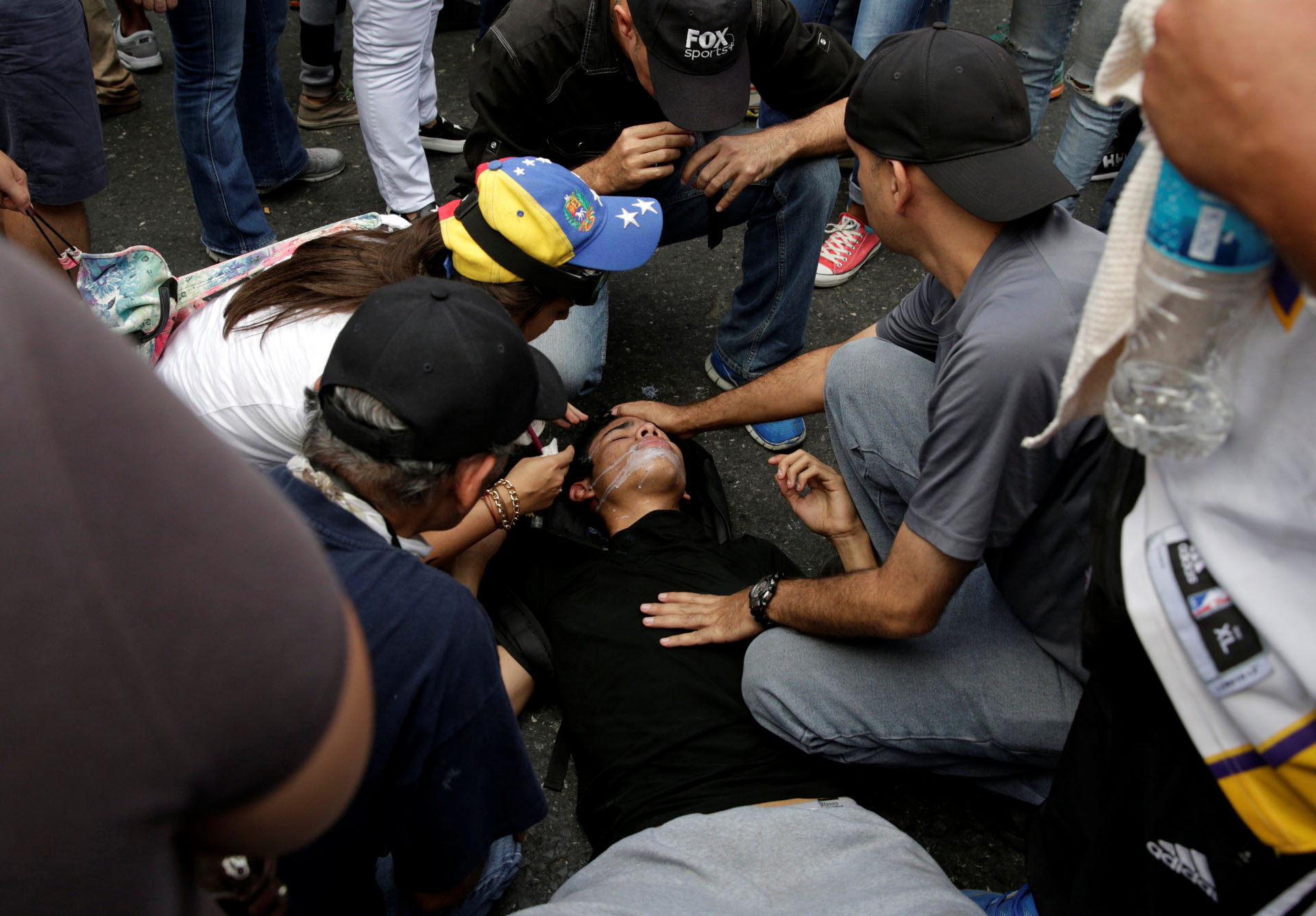 Demonstrators attend to a fellow protester during an opposition rally in Caracas, Venezuela, April 6, 2017. REUTERS/Carlos Garcia Rawlins