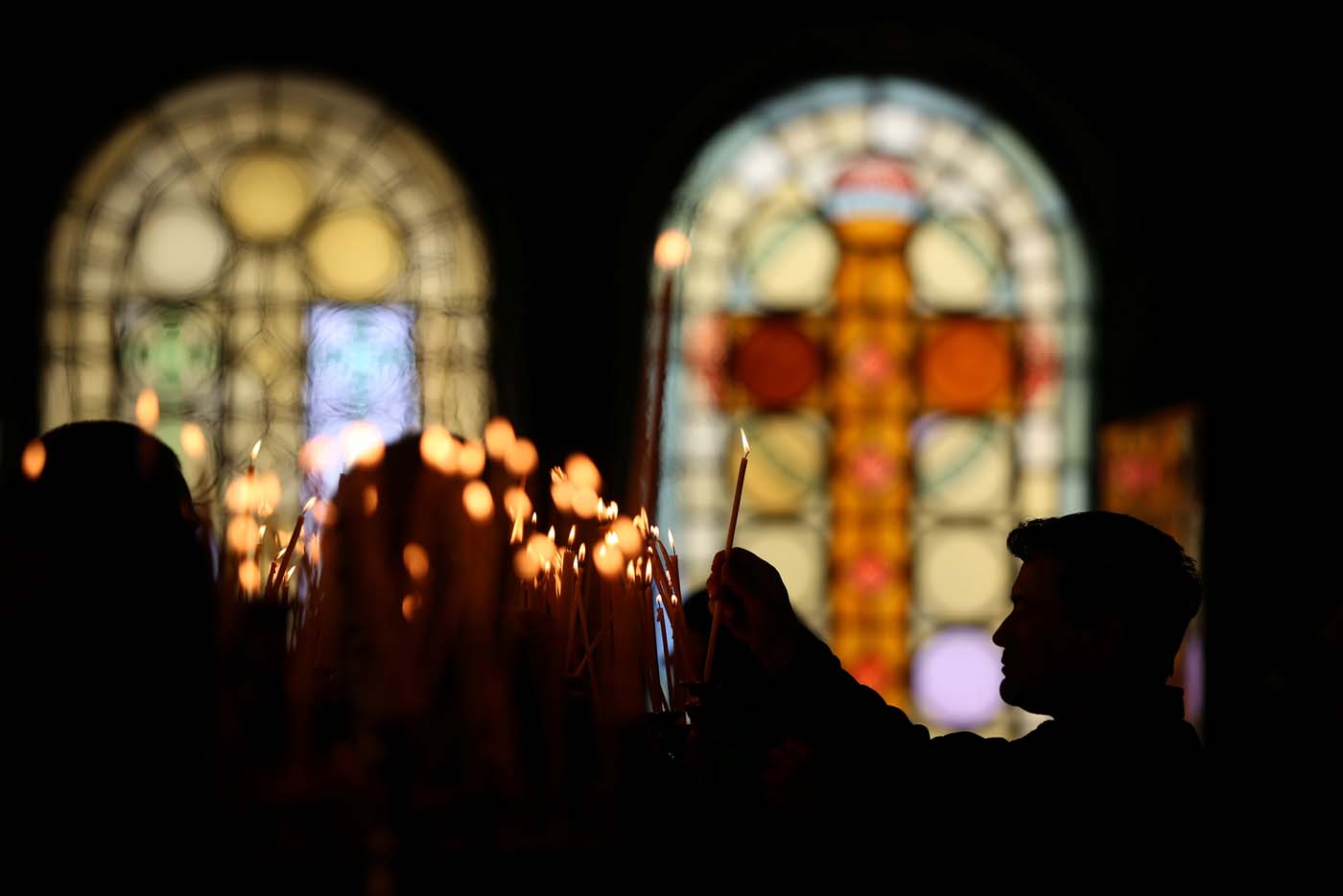 Worshippers light candles during the Palm Sunday service in Alexander Nevsky Cathedral in Sofia, Bulgaria April 9, 2017. REUTERS/Stoyan Nenov