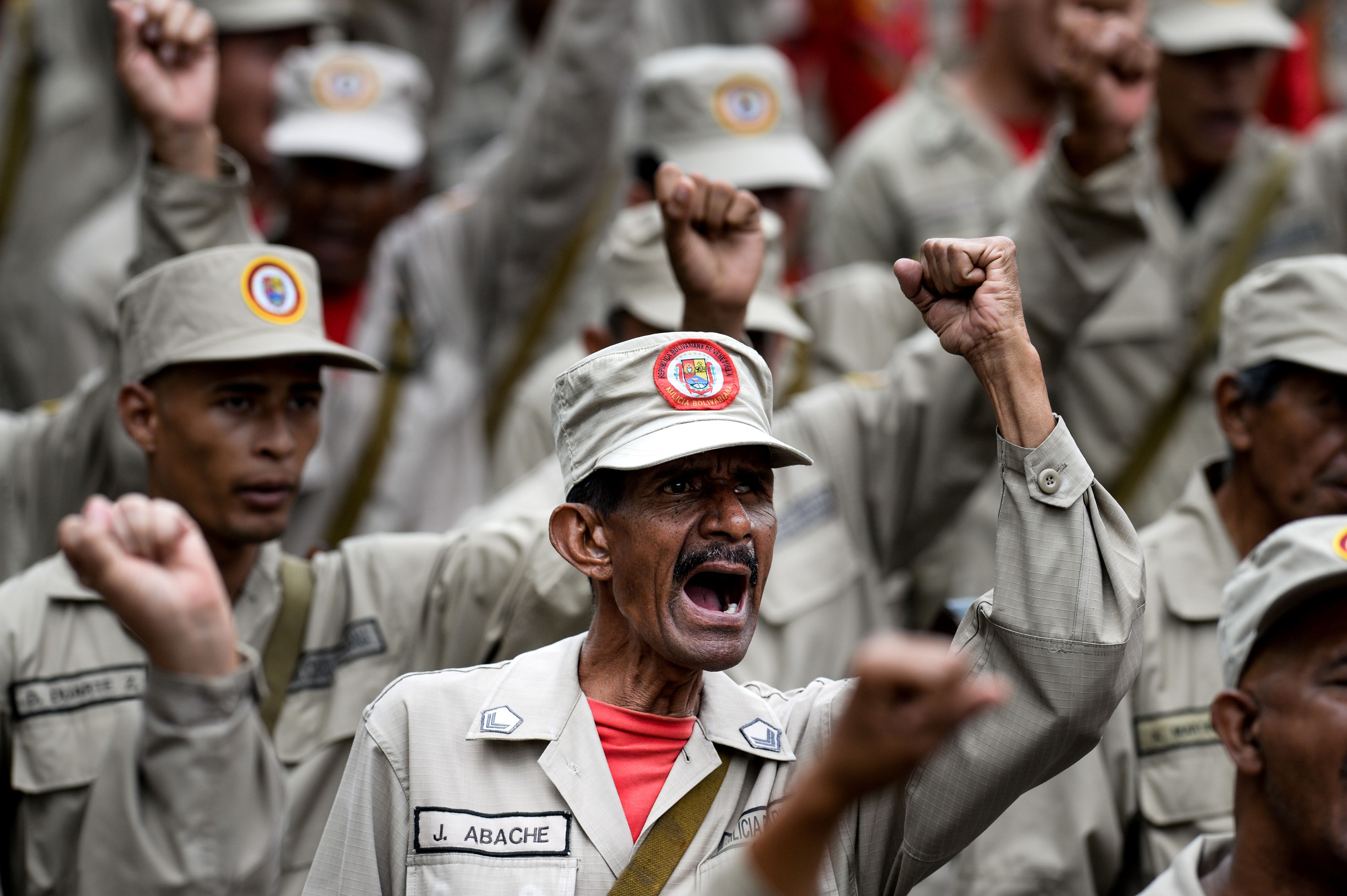Members of the Bolivarian Militia take part in a parade in the framework of the seventh anniversary of the force, in front of the Miraflores presidential palace in Caracas on April 17, 2017. Venezuela's defence minister on Monday declared the army's loyalty to Maduro, who ordered troops into the streets ahead of a major protest by opponents trying to oust him. Venezuela is bracing for what Maduro's opponents vow will be the "mother of all protests" Wednesday, after two weeks of violent demos against moves by the leftist leader and his allies to tighten their grip on power. / AFP PHOTO / Federico PARRA