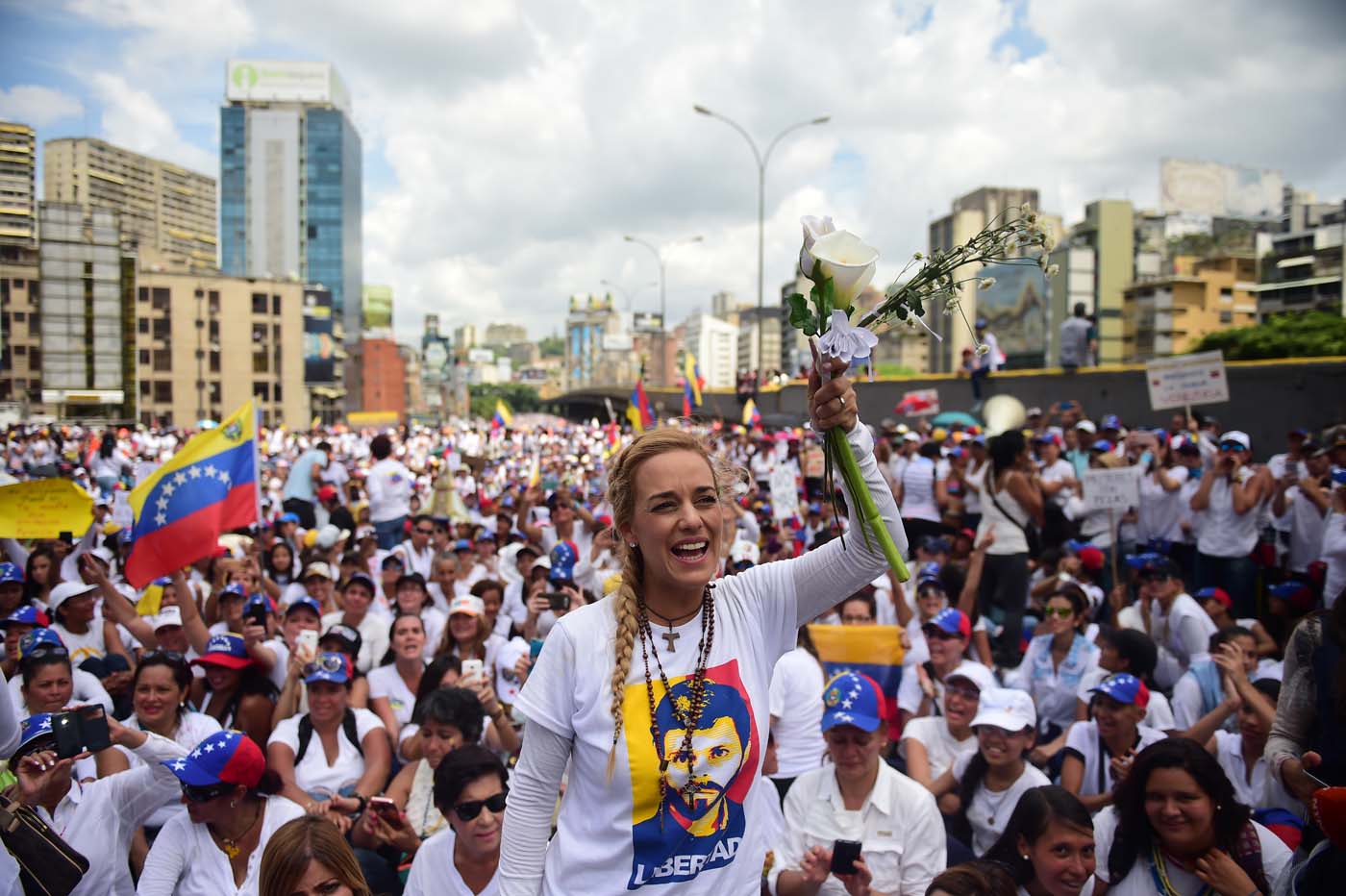 The wife of imprisoned opposition leader Leopoldo Lopez, Lilian Tintori (C), takes part in a women's march aimed to keep pressure on President Nicolas Maduro, whose authority is being increasingly challenged by protests and deadly unrest, in Caracas on May 6, 2017. The death toll since April, when the protests intensified after Maduro's administration and the courts stepped up efforts to undermine the opposition, is at least 36 according to prosecutors. / AFP PHOTO / RONALDO SCHEMIDT