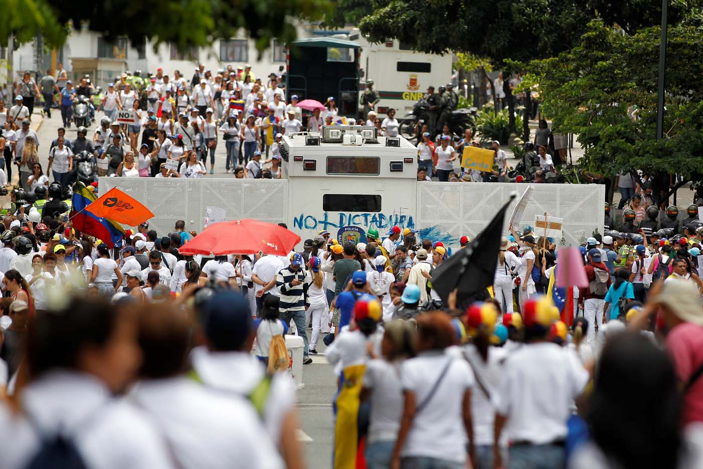 Demonstrators gather in front of the police during a women's march to protest against President Nicolas Maduro's government in Caracas, Venezuela May 6, 2017. REUTERS/Christian Veron