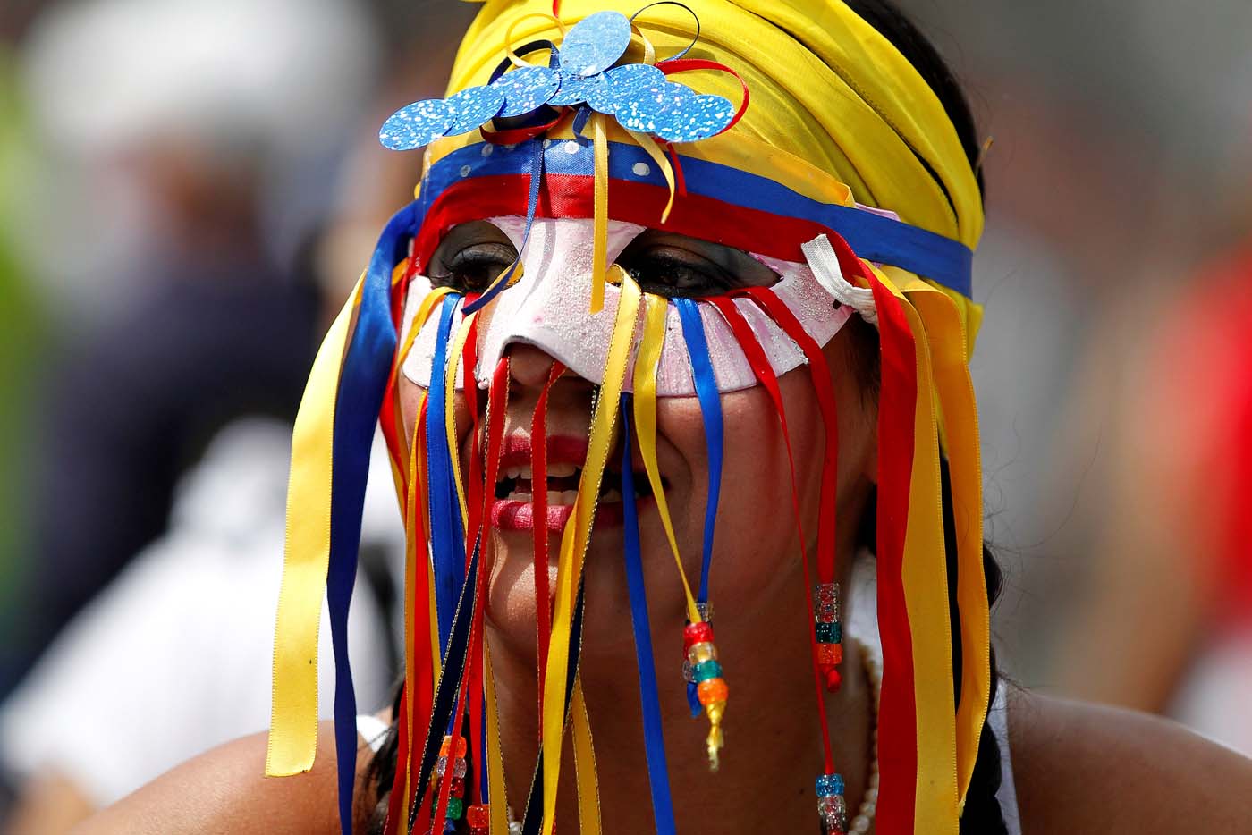 A woman wears a mask during a women's march to protest against President Nicolas Maduro's government in Caracas, Venezuela May 6, 2017. REUTERS/Christian Veron
