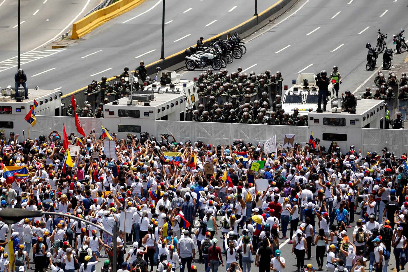 Demonstrators gather in front of the police as they attend a women's march to protest against President Nicolas Maduro's government in Caracas, Venezuela May 6, 2017. REUTERS/Christian Veron